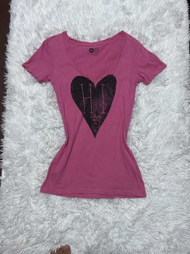 Roxy Pink Hawaii Graphic V-Neck Tee Medium (Category: Shirts) located in Tuguegarao City. Submitted by love_clothies (Listing ID 1466605476, Image 1). Description: - Brand: Roxy - Color: Pink with black heart and Hawaii graphic - Size: Medium - Material: 100% cotton (soft and breathable) - Fit: Standard fit with short sleeves - Care: Machine washable - Condition: Excellent / Pre-loved - Size: Small to Medium.