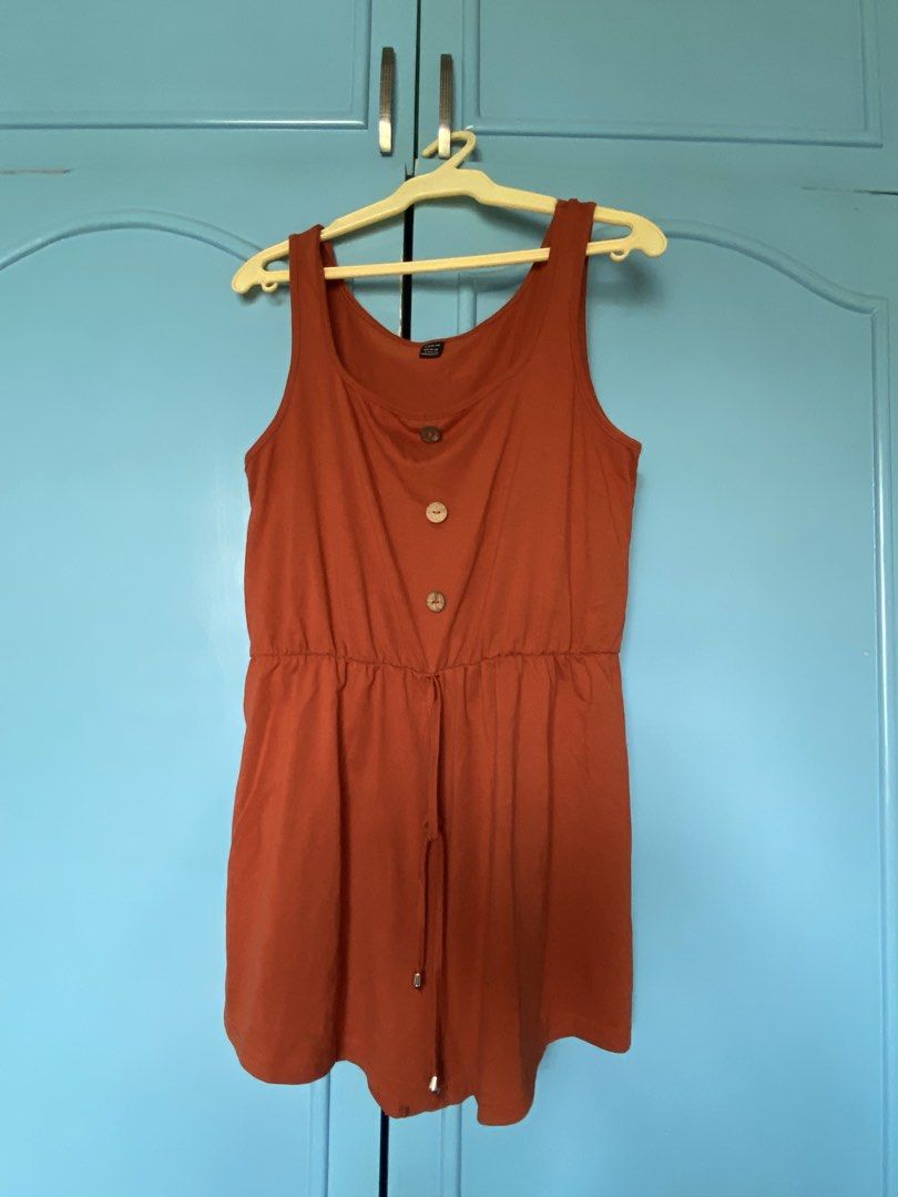Rust Orange Tank Romper with Buttons (Category: Rompers) located in Las Pinas. Submitted by jhelting (Listing ID 1466677704, Image 2). Description: - Color: Rust orange - Style: Sleeveless romper / one-piece - Neckline: Scoop neck with 3 wooden decorative buttons - Waist: Elastic waistband with matching drawstring - Fabric: Lightweight and comfortable for everyday wear.