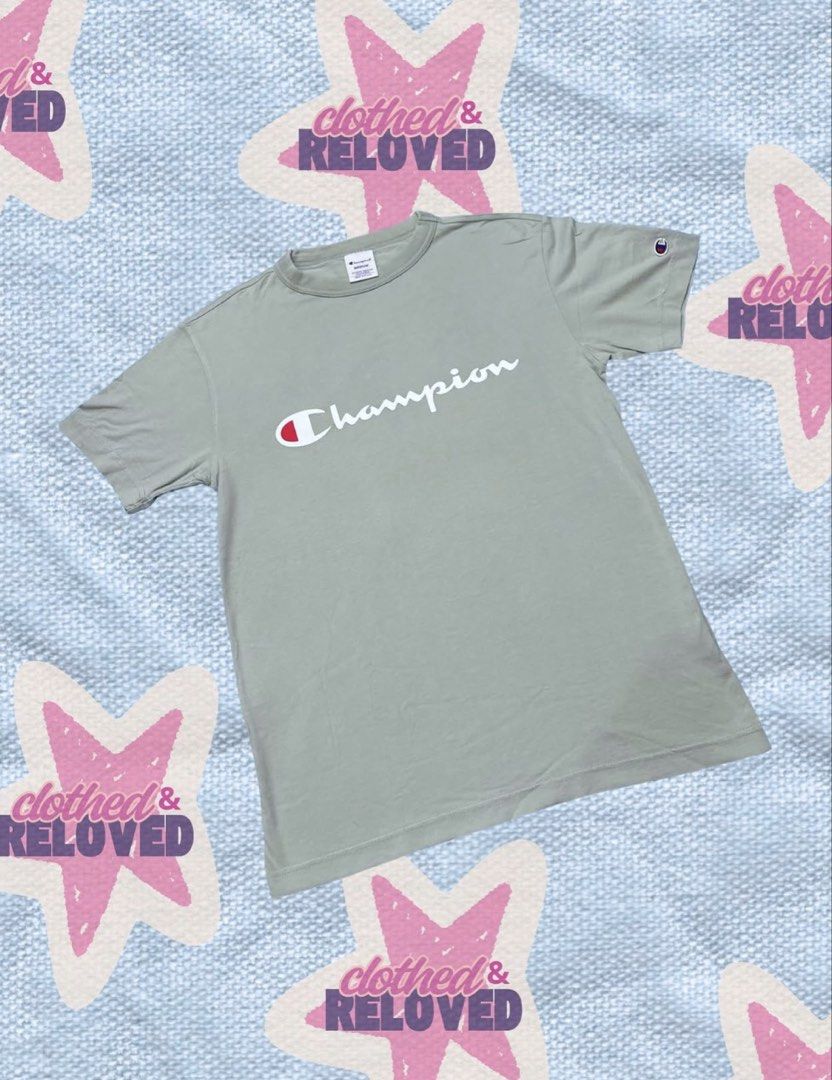 Sage Green T-Shirt (Category: Shirts) located in Binan City. Submitted by szummie (Listing ID 1466620795, Image 1). Description: - Brand: Champion - Color: Sage green - Size/Fit: Standard fit - Material: 100% cotton - Design: Script logo across chest with embroidered sleeve patch - Condition: Excellent, clean with no flaws or stains.