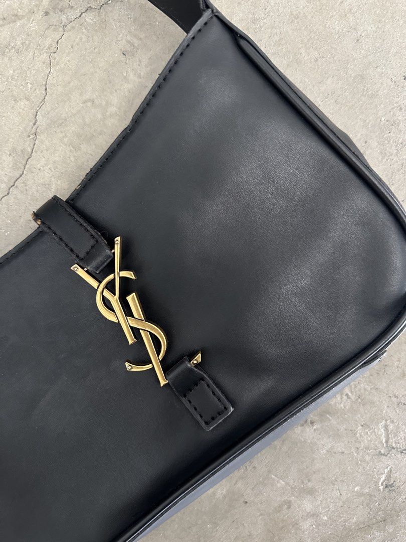 Saint Laurent Black Leather Shoulder Bag (Category: Luxury Bags & Wallets) located in Mandaluyong City. Submitted by dhanlumanas (Listing ID 1466770964, Image 2). Description: Saint Laurent black leather shoulder bag with gold-tone hardware. Classic YSL logo in the center front and Saint Laurent Paris branding engraved on the buckle. Adjustable shoulder strap. Clean minimalist shape, easy to style with different outfits. Minimal wear on the edges