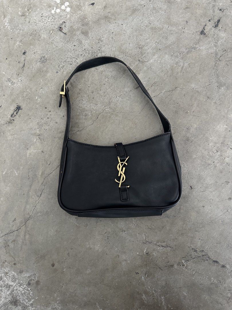 Saint Laurent Black Leather Shoulder Bag (Category: Luxury Bags & Wallets) located in Mandaluyong City. Submitted by dhanlumanas (Listing ID 1466770964, Image 3). Description: Saint Laurent black leather shoulder bag with gold-tone hardware. Classic YSL logo in the center front and Saint Laurent Paris branding engraved on the buckle. Adjustable shoulder strap. Clean minimalist shape, easy to style with different outfits. Minimal wear on the edges