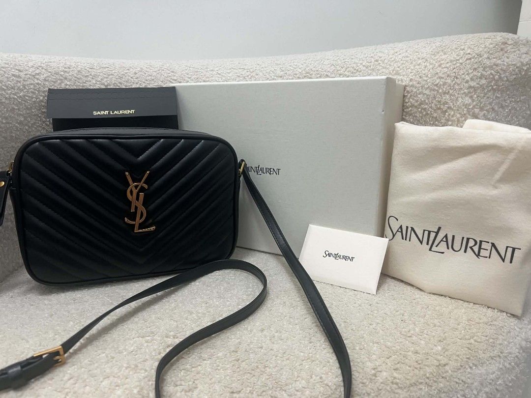 Saint Laurent Lou Camera Bag Black (Category: Cross-body Bags) located in Paoay. Submitted by rvf1230 (Listing ID 1466563897, Image 2). Description: - Authentic Saint Laurent Lou camera bag in timeless black chevron leather - Luxurious gold-tone hardware and chic leather tassel detail - Secure zip closure with an adjustable crossbody strap for daily comfort - Pristine condition: clean interior and exterior with no noticeable scuffs or marks - Com