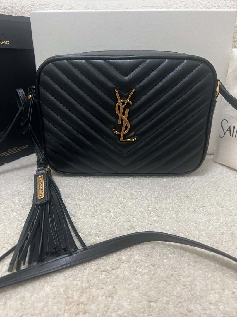 Saint Laurent Lou Camera Bag Black (Category: Cross-body Bags) located in Paoay. Submitted by rvf1230 (Listing ID 1466563897, Image 3). Description: - Authentic Saint Laurent Lou camera bag in timeless black chevron leather - Luxurious gold-tone hardware and chic leather tassel detail - Secure zip closure with an adjustable crossbody strap for daily comfort - Pristine condition: clean interior and exterior with no noticeable scuffs or marks - Com
