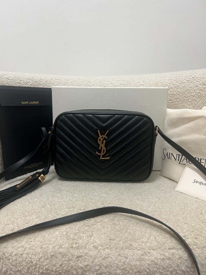 Saint Laurent Lou Camera Bag Black (Category: Cross-body Bags) located in Paoay. Submitted by rvf1230 (Listing ID 1466563897, Image 1). Description: - Authentic Saint Laurent Lou camera bag in timeless black chevron leather - Luxurious gold-tone hardware and chic leather tassel detail - Secure zip closure with an adjustable crossbody strap for daily comfort - Pristine condition: clean interior and exterior with no noticeable scuffs or marks - Com