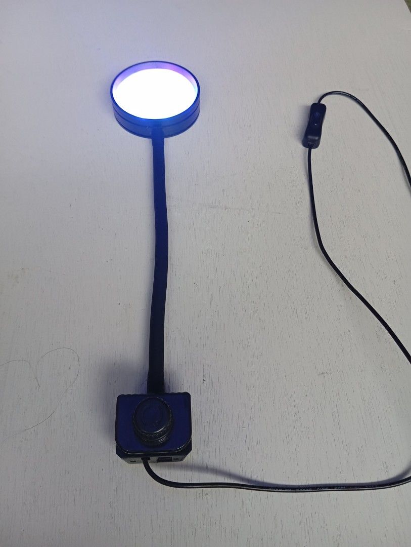 Salt water Aquarium Light (Category: Homes & Other Pet Accessories) located in Caloocan City. Submitted by jonmag31 (Listing ID 1466770120, Image 2). Description: - Flexible gooseneck desk lamp with a round LED head - Features multi-color lighting options (blue, white, and pinkish hues) - Sturdy black clamp base with a convenient rotary control knob - Attached black power cord with an easy-to-use inline toggle switch - Clean overall condition and
