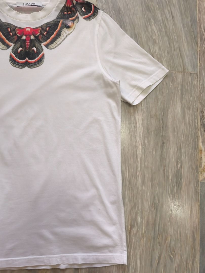 "SAMPLE" Givenchy Cecropia Moth Graphic T-Shirt - SS15 (Category: Tshirts & Polo Shirts ) located in Lucena. Submitted by 0174.archive (Listing ID 1466680131, Image 3). Description: The shirt in the image is an iconic Givenchy Cecropia Moth Graphic T-Shirt, originally designed by Riccardo Tisci for the Spring/Summer 2015 collection. This specific graphic print series became a hallmark of Givenchy's luxury streetwear era and was worn by several hi