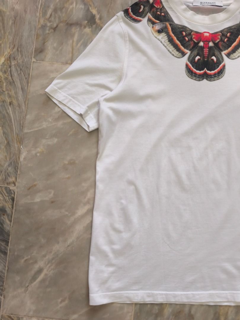 "SAMPLE" Givenchy Cecropia Moth Graphic T-Shirt - SS15 (Category: Tshirts & Polo Shirts ) located in Lucena. Submitted by 0174.archive (Listing ID 1466680131, Image 2). Description: The shirt in the image is an iconic Givenchy Cecropia Moth Graphic T-Shirt, originally designed by Riccardo Tisci for the Spring/Summer 2015 collection. This specific graphic print series became a hallmark of Givenchy's luxury streetwear era and was worn by several hi