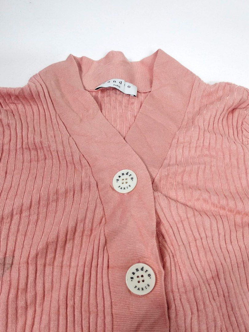 Sandro Paris Pink Ribbed Knit Cardigan (Category: Coats, Jackets and Outerwear) located in Manila. Submitted by naphthrift (Listing ID 1466577242, Image 3). Description: Sandro Paris Knit Pech Color Condition : Verygood Size : 3 Dimension 👇 Chest : 15-23 Lenght : 24 Shoulder : 12-17 Sleeve : 22 📌 - Brand: Sandro Paris - Color: Pink - Size: LT (Paris label) - Material: Soft knit with fine vertical ribbing - Style: V-neck with branded white butto