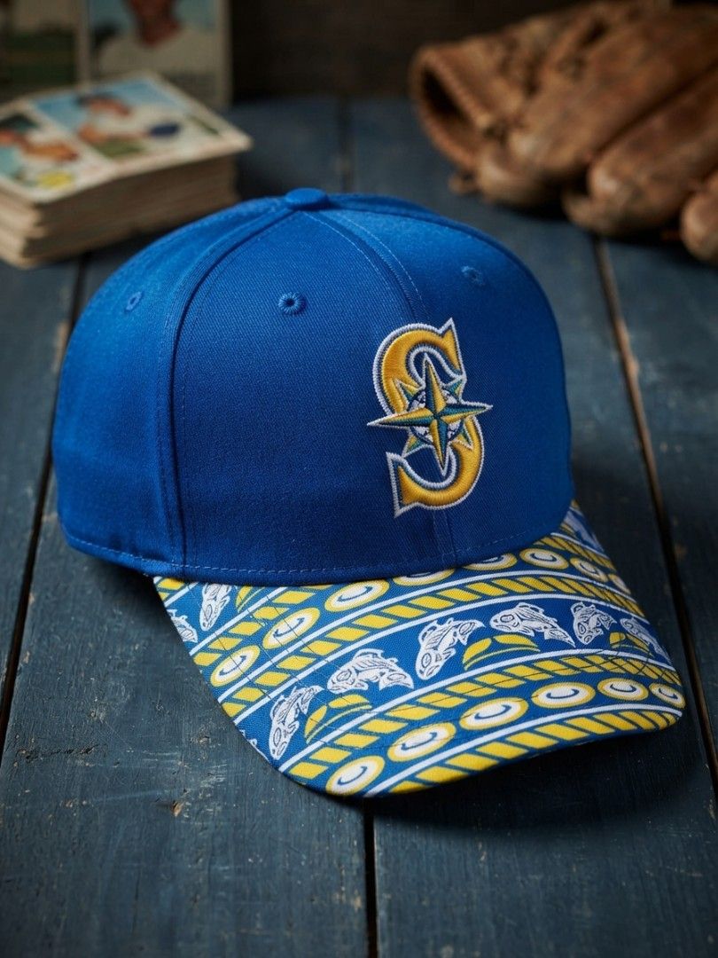 Seattle Mariners Inspired Blue & Gold Patterned Baseball Cap (Category: Caps & Hats) located in Binangonan. Submitted by yuristalin888 (Listing ID 1466711516, Image 1). Description: A stylish blue baseball cap featuring an embroidered compass-style S logo in gold and white, paired with a distinctive blue-and-gold patterned brim decorated with nautical-inspired motifs. Made from cotton with an adjustable back closure, this unique cap combines spor