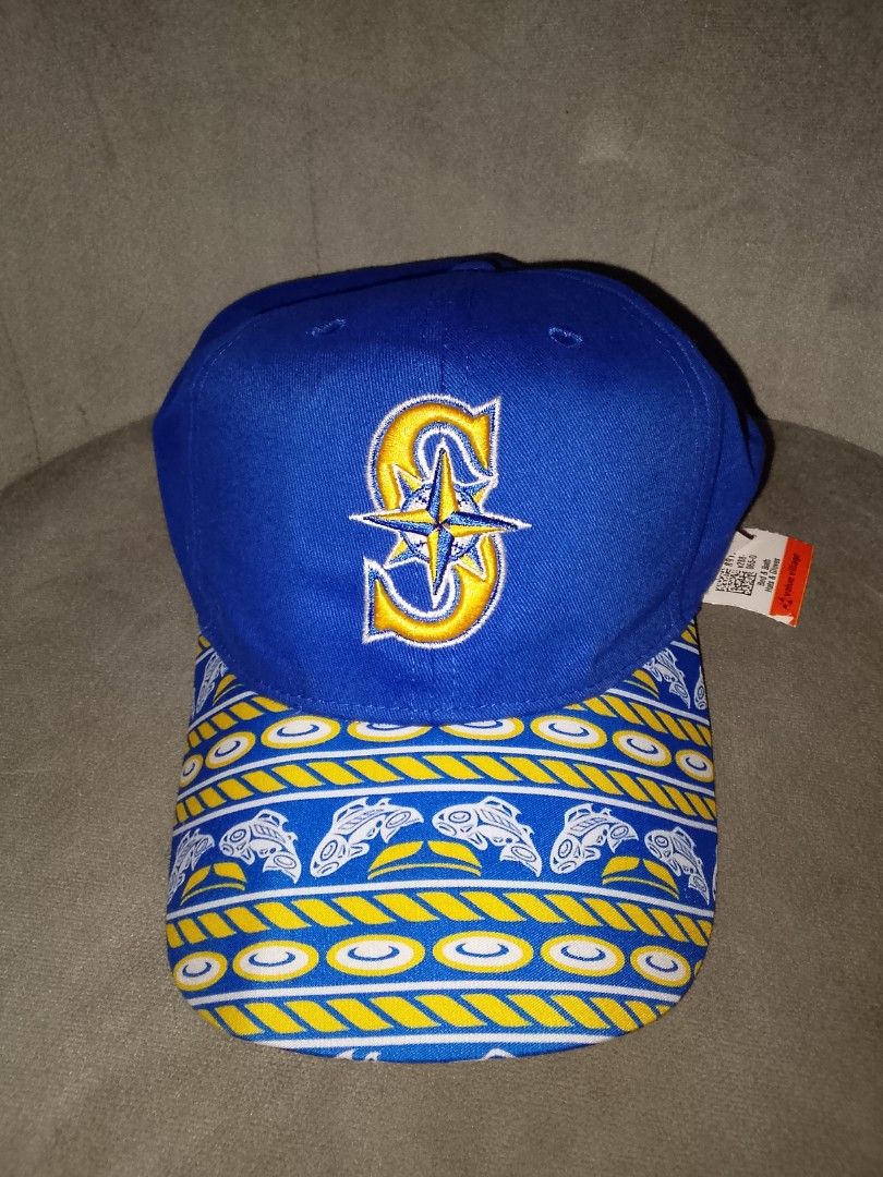 Seattle Mariners Inspired Blue & Gold Patterned Baseball Cap (Category: Caps & Hats) located in Binangonan. Submitted by yuristalin888 (Listing ID 1466711516, Image 2). Description: A stylish blue baseball cap featuring an embroidered compass-style S logo in gold and white, paired with a distinctive blue-and-gold patterned brim decorated with nautical-inspired motifs. Made from cotton with an adjustable back closure, this unique cap combines spor