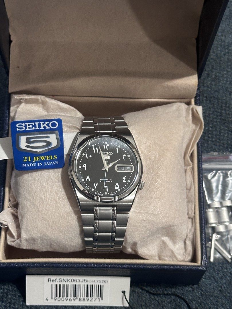 Seiko 5 Arabic Dial SNK063J5 Automatic Watch (Category: Men's Watches) located in Makati City. Submitted by rnavarrojr (Listing ID 1466719311, Image 1). Description: - Brand: Seiko 5 Automatic - Model / Ref: SNK063J5 (Made in Japan) - Movement: Calibre 7S26, 21 Jewels - Dial: Black with Arabic numerals - Material: Stainless steel case and bracelet - Case Back: Exhibition glass back - Inclusions: Original box, tag, and extra links.