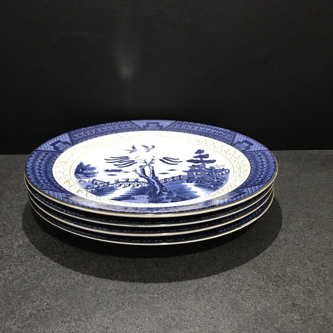 Set of 4 blue and white willow pattern plates (Category: Dinnerware & Cutlery) located in Baao. Submitted by all.things.japan (Listing ID 1466715906, Image 1). Description: - Set of 4 blue and white ceramic plates - Classic willow scene featuring intricate pagoda, bridge, and tree motifs - Detailed geometric blue border with elegant gold accent trim - Clean, glossy finish on all surfaces - Heavy-duty stacking capability - Traditional dinnerware s