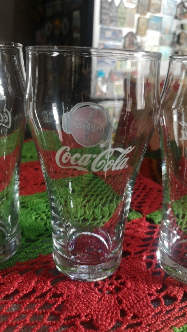 Set of 4 Coca-Cola Glasses (Category: Dinnerware & Cutlery) located in Quezon City. Submitted by prelovedqcseller (Listing ID 1466585165, Image 3). Description: - Set of 4 vintage Coca-Cola clear glass tumblers - Features classic graphics and logo - Standard drinking shape with a sturdy, heavy base - Height: Approx. 12.5 cm - Great addition to any bar cart or retro kitchen collection.