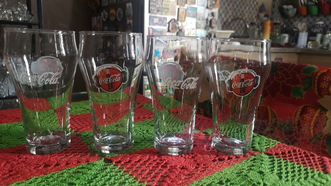 Set of 4 Coca-Cola Glasses (Category: Dinnerware & Cutlery) located in Quezon City. Submitted by prelovedqcseller (Listing ID 1466585165, Image 1). Description: - Set of 4 vintage Coca-Cola clear glass tumblers - Features classic graphics and logo - Standard drinking shape with a sturdy, heavy base - Height: Approx. 12.5 cm - Great addition to any bar cart or retro kitchen collection.