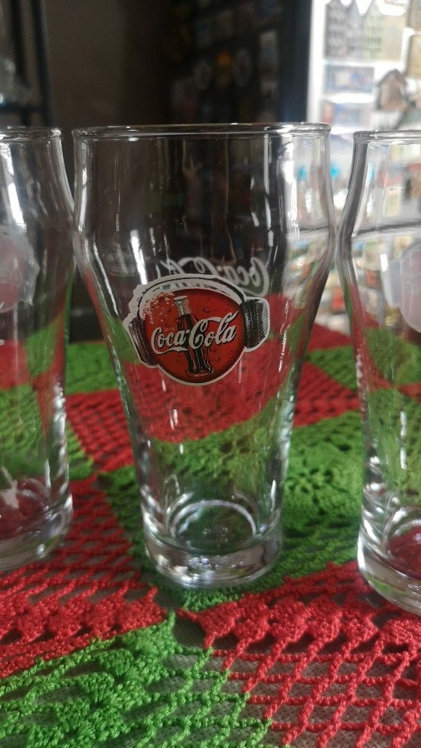 Set of 4 Coca-Cola Glasses (Category: Dinnerware & Cutlery) located in Quezon City. Submitted by prelovedqcseller (Listing ID 1466585165, Image 2). Description: - Set of 4 vintage Coca-Cola clear glass tumblers - Features classic graphics and logo - Standard drinking shape with a sturdy, heavy base - Height: Approx. 12.5 cm - Great addition to any bar cart or retro kitchen collection.