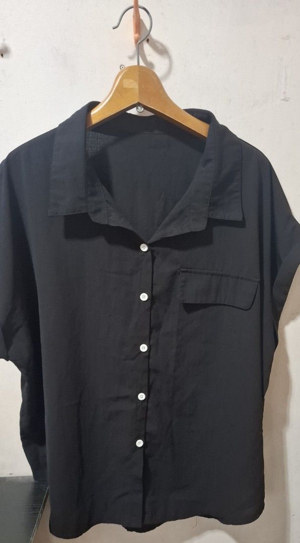 SHEIN Black Short Sleeve Button-Up Shirt (Category: Shirts) located in Cabuyao City. Submitted by gaile29 (Listing ID 1466623590, Image 1). Description: Black short sleeve button-up shirt from SHEIN. Features a collar, chest pocket, and white buttons down the front. Material tag shows 65% cotton and 35% polyester. Made in China. Easy to style with denim or trousers..