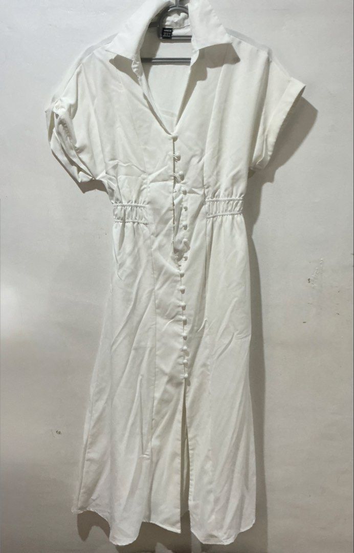 SHEIN Button Up White Dress (Category: Dresses) located in San Pedro. Submitted by itsannabg (Listing ID 1466603692, Image 1). Description: - Brand: SHEIN - Style: White midi shirt dress with lapel collar and short sleeves - Closure: Full front button closure - Fit: Smocked elastic waist for a fitted silhouette - Material: Lightweight fabric - Size: XS (EU 34, US 2) - Condition: Clean, worn only once for my child Baptism.