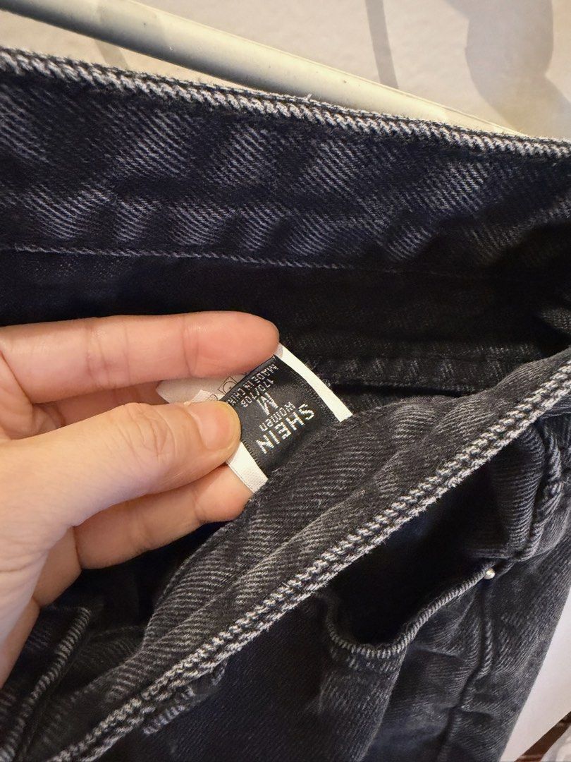 SHEIN Distressed Black Denim Jeans Size M (Category: Jeans) located in Quezon City. Submitted by bubspreloved (Listing ID 1466721154, Image 3). Description: - Brand: Shein - Size: Medium (Brand new with tag attached) - Color: Black wash - Rise: Mid-rise fit - Details: Ripped knees and trendy raw rolled cuffs - Closure: Standard button and zip fly - Pockets: Classic five-pocket design.