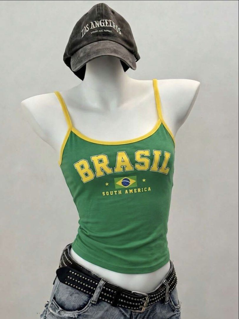 Shein Green Cami Cropped Tank Top (Category: Sleeveless) located in Manila. Submitted by dianafayesimbre (Listing ID 1466770968, Image 3). Description: - Color: Green with yellow trim - Design: Bold 'BRASIL' lettering, flag print, and 'SOUTH AMERICA' text - Fit: Fitted style with adjustable straps - Material: Lightweight and comfortable fabric - Styling: Great for casual wear, denim shorts, or skirts.