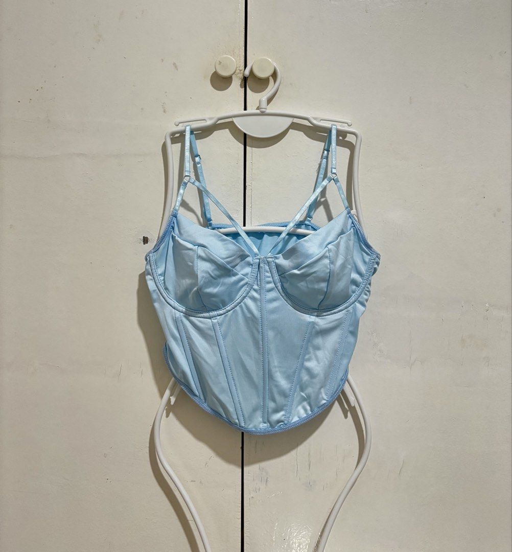 Shein Light Blue Corset Crop Top (Category: Sleeveless) located in Manila. Submitted by dianafayesimbre (Listing ID 1466771235, Image 1). Description: - Color: Light Blue - Material: Luxurious satin - Design: Structured underwire cups with front boning detail - Straps: Adjustable spaghetti straps with a front criss-cross design - Back: Open back cut-out with a straight neckline - Hem: Trendy curved hemline cropped length - Size M on tag but can f