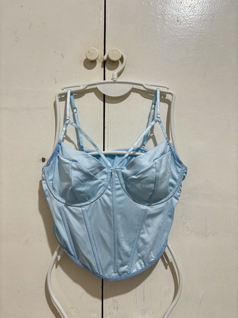 Shein Light Blue Corset Crop Top (Category: Sleeveless) located in Manila. Submitted by dianafayesimbre (Listing ID 1466771235, Image 2). Description: - Color: Light Blue - Material: Luxurious satin - Design: Structured underwire cups with front boning detail - Straps: Adjustable spaghetti straps with a front criss-cross design - Back: Open back cut-out with a straight neckline - Hem: Trendy curved hemline cropped length - Size M on tag but can f