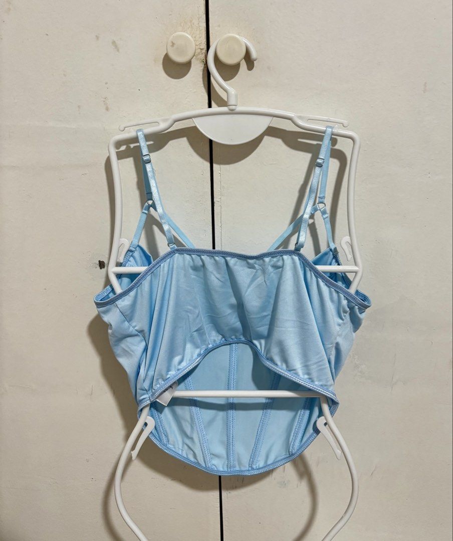 Shein Light Blue Corset Crop Top (Category: Sleeveless) located in Manila. Submitted by dianafayesimbre (Listing ID 1466771235, Image 3). Description: - Color: Light Blue - Material: Luxurious satin - Design: Structured underwire cups with front boning detail - Straps: Adjustable spaghetti straps with a front criss-cross design - Back: Open back cut-out with a straight neckline - Hem: Trendy curved hemline cropped length - Size M on tag but can f