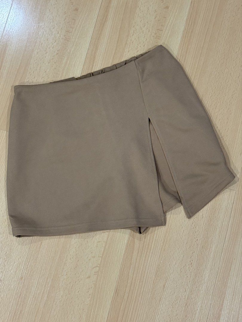 SHEIN Tan/Khaki Overlapping Asymmetric Skort (Size M) (Category: Skirts) located in Muntinlupa City. Submitted by alexisofia (Listing ID 1466733269, Image 2). Description: Super cute and versatile tan/khaki skort featuring an overlapping, asymmetrical wrap-around front panel with a stylish side split—giving you the effortless look of a skirt with the comfort and coverage of built-in shorts. like new / excellent condition (worn only a few times) M