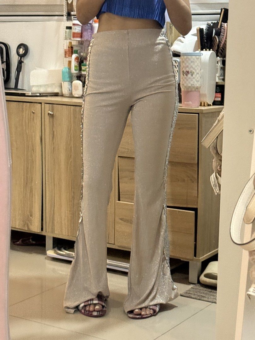 Sparkly beige flared pants with silver side panels (Category: Jeans) located in Manila. Submitted by mightystone-d948cd (Listing ID 1466771764, Image 2). Description: - Color & Style: Sparkly beige high-waisted flared pants with striking silver sequin-style side panels - Fit: Fitted through hips and thighs with a dramatic flare at the bottom and slightly pooling long length - Fabric: Comfortable, stretchy material for a flattering fit - Occasion: