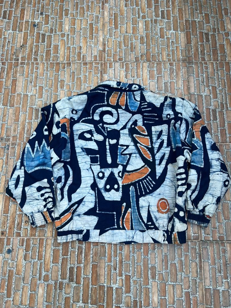 Splendour Abstract Print Bomber Jacket Size M (Category: Coats, Jackets and Outerwear) located in Caloocan City. Submitted by sillapwet0606 (Listing ID 1466564629, Image 2). Description: - Brand/Model: Splendour jacket - Size: Medium (M) - Design: Dark blue base with heavy white and orange abstract art patterns - Interior: Vibrant green lining inside the body and Chinese text on the brand tag - Features: Elastic hem and cuffs for a comfortable fi