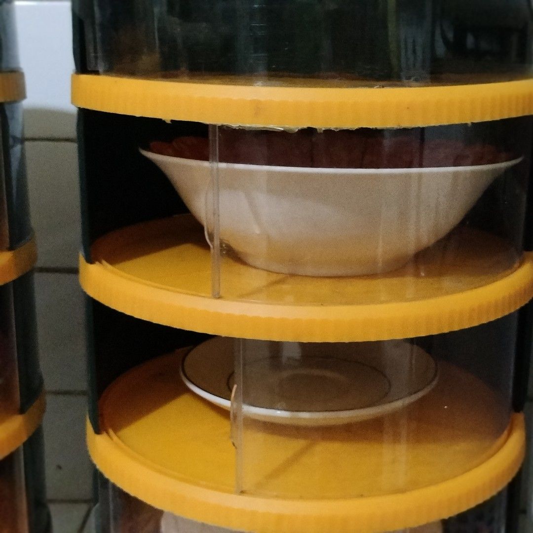 Multi-Tier Dish Rack Storage Container Set (Category: Food Organization & Storage) located in Pasig City. Submitted by hapibibiness (Listing ID 1466682509, Image 3). Description: - Multi-tier dish storage towers - Stylish dark green lids with vibrant orange trim and clear walls - Keeps plates, bowls, and saucers dust-free and organized - Convenient sliding door panels for easy individual tier access - Perfect space-saving solution for small kitch