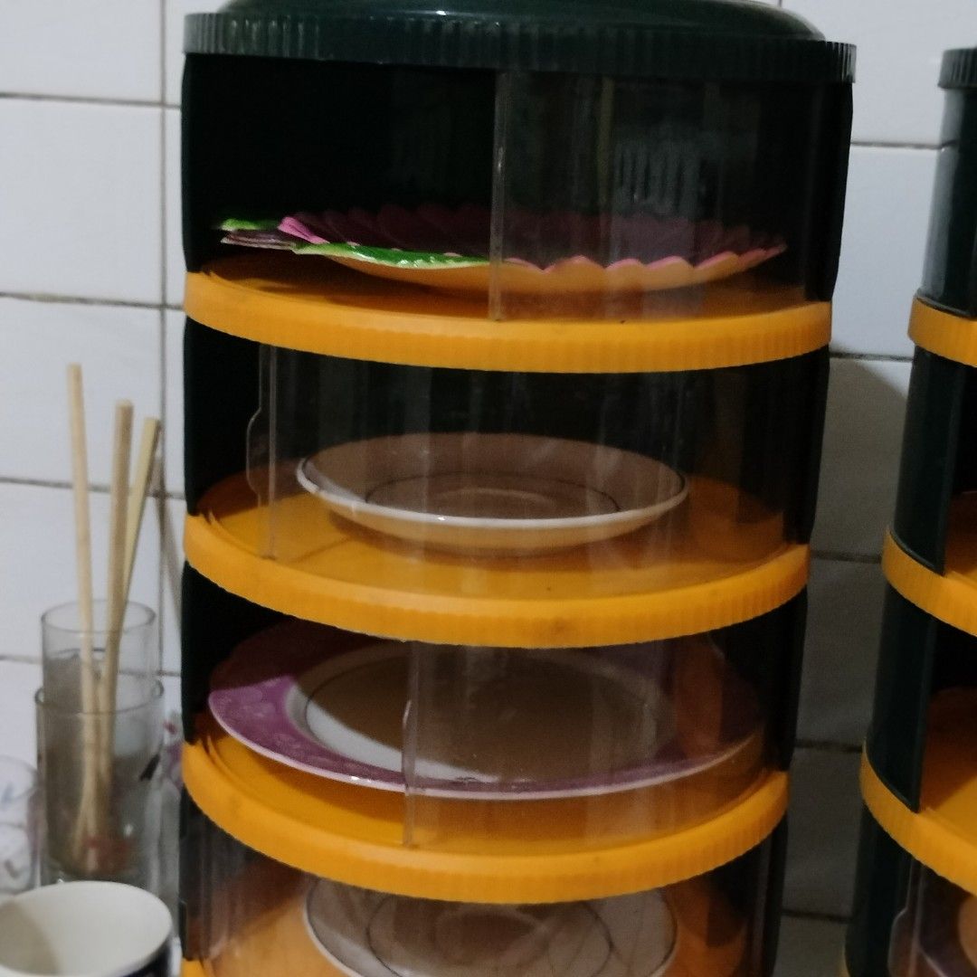 Multi-Tier Dish Rack Storage Container Set (Category: Food Organization & Storage) located in Pasig City. Submitted by hapibibiness (Listing ID 1466682509, Image 2). Description: - Multi-tier dish storage towers - Stylish dark green lids with vibrant orange trim and clear walls - Keeps plates, bowls, and saucers dust-free and organized - Convenient sliding door panels for easy individual tier access - Perfect space-saving solution for small kitch