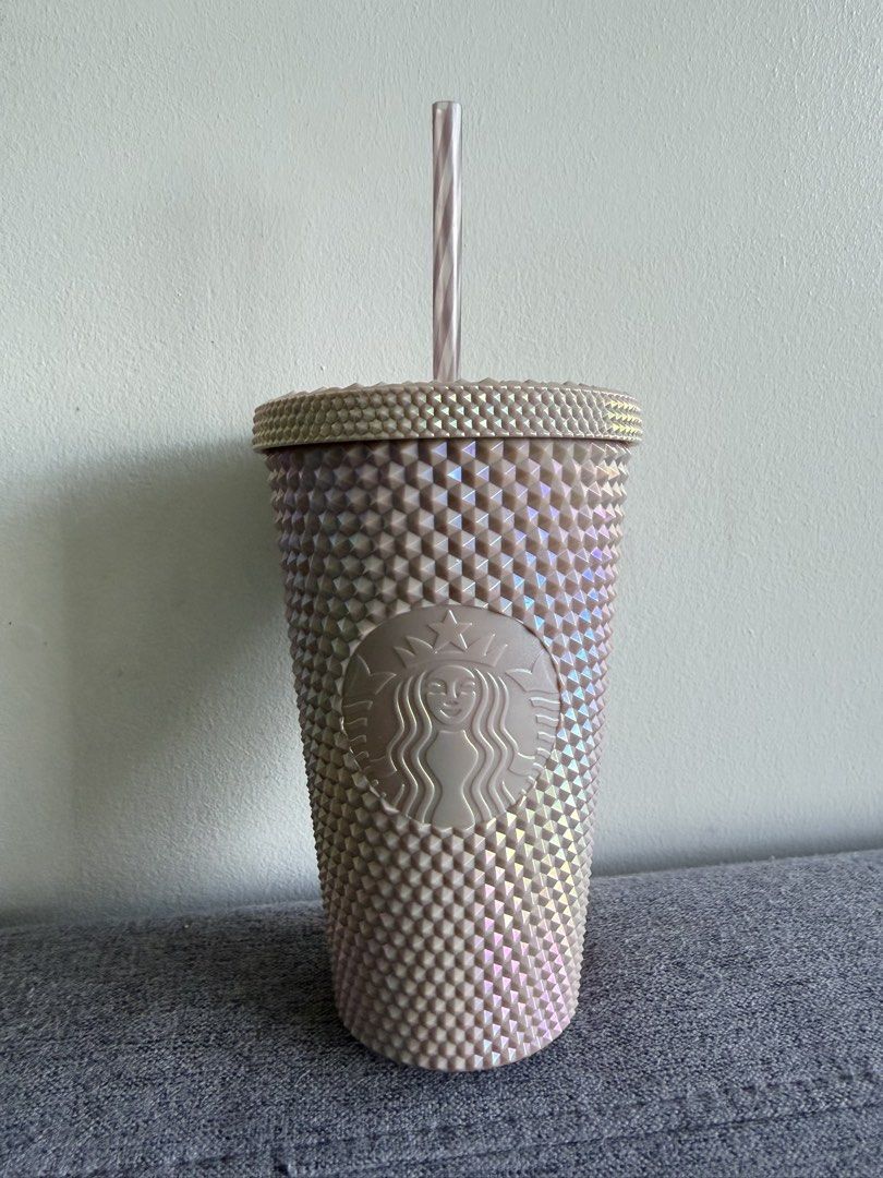 Starbucks Studded Cold Cup (Category: Water Bottles & Tumblers) located in Manila. Submitted by mal.eficent (Listing ID 1466630132, Image 1). Description: -100% Authentic Starbucks studded tumbler in a gorgeous Rose Gold color -Holographic effect - Capacity: 16 fl oz / 473 ml (Grande size) - Textured geometric design all over the cup and matching striped straw - Includes secure matching lid - Care instructions: For cold beverages only, hand wash 