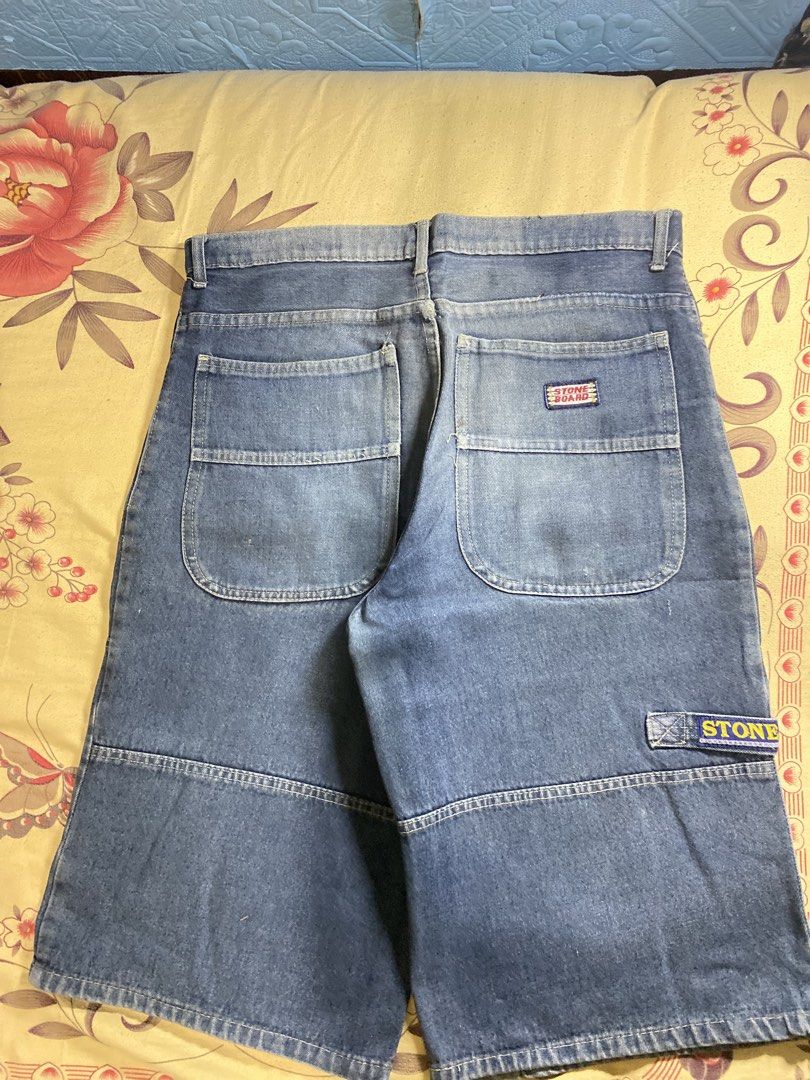 Stone Board Denim Jeans (Category: Jeans) located in Bacolor. Submitted by paw_thrift (Listing ID 1466690108, Image 2). Description: - Brand: Stone Board - Color/Wash: Mid wash blue denim with natural fading - Details: Stylish leg panels, back pockets with woven logo, and small badge on right leg pocket - Closure: Classic button and zip fly - Condition: Pre-owned with great vintage appeal.