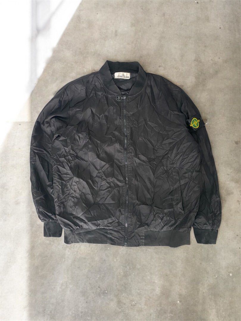 Stone Island Black Bomber Jacket with Sleeve Patch (Category: Coats, Jackets and Outerwear) located in General Trias. Submitted by mangu_ukay (Listing ID 1466673296, Image 1). Description: - Black Stone Island bomber jacket - Color: Black - Zip front closure with branded pull - Iconic compass sleeve badge (two- -issue no puller isang pocket zipper button attachment) - Large embroidered compass logo on the back - Comfortable ribbed collar, cuffs, 