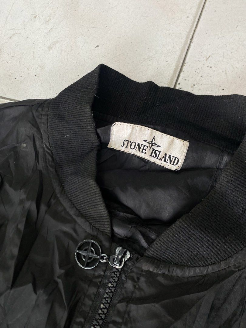 Stone Island Black Bomber Jacket with Sleeve Patch (Category: Coats, Jackets and Outerwear) located in General Trias. Submitted by mangu_ukay (Listing ID 1466673296, Image 2). Description: - Black Stone Island bomber jacket - Color: Black - Zip front closure with branded pull - Iconic compass sleeve badge (two- -issue no puller isang pocket zipper button attachment) - Large embroidered compass logo on the back - Comfortable ribbed collar, cuffs, 