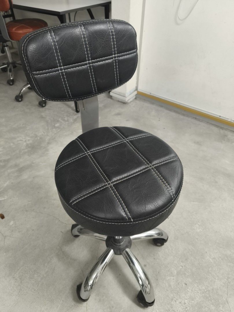 Stool (Category: Chairs) located in Kuala Lumpur. Submitted by frhnmis (Listing ID 1466699718, Image 3). Description: Black faux leather rolling stool with quilted grid stitching. Chrome 5-star base with smooth-rolling caster wheels. Adjustable height gas lift mechanism. Cushioned backrest attached via sturdy metal spine. Clean upholstery, minimal wear. Great for salon, studio, office, or workshop setup. - Price RM100 can nego a bit.