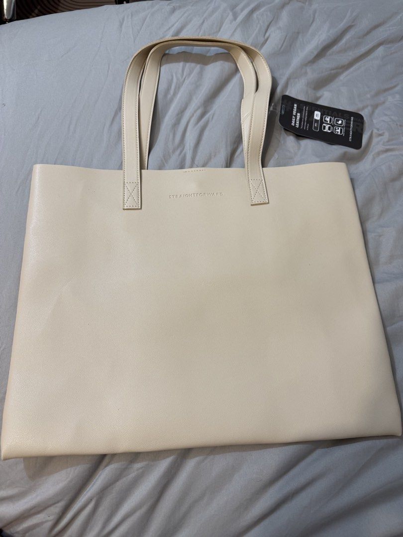 Straightforward Daily Vegan Leather Tote Bag (Category: Tote Bags) located in Trece Martires City. Submitted by wildshark554 (Listing ID 1466729471, Image 2). Description: - Condition: Brand new with tags attached - Material: Durable, water-resistant vegan leather - Design: Clean minimalist style with an embossed front logo and double shoulder straps - Colors available: Maroon, beige, brown, and tan - Perfect for daily use and work.