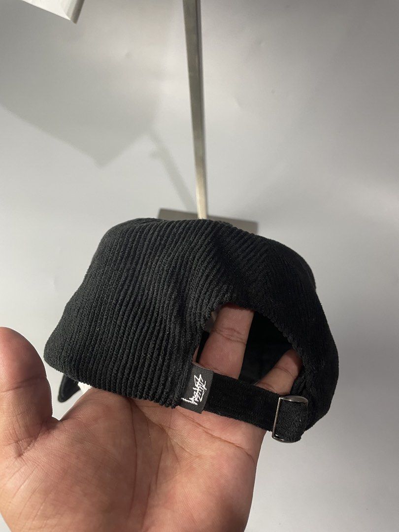 Stüssy Black Corduroy Cap (Category: Caps & Hats) located in Veruela. Submitted by blinkban_thrift (Listing ID 1466575791, Image 2). Description: - Brand: Stüssy - Style: Black corduroy hat with white embroidered logo - Collection: Spring '24 (Style #1311088) - Material: 100% polyester - Fit: One size fits all with adjustable strap closure - Condition: Clean all around, excellent pre-loved condition.