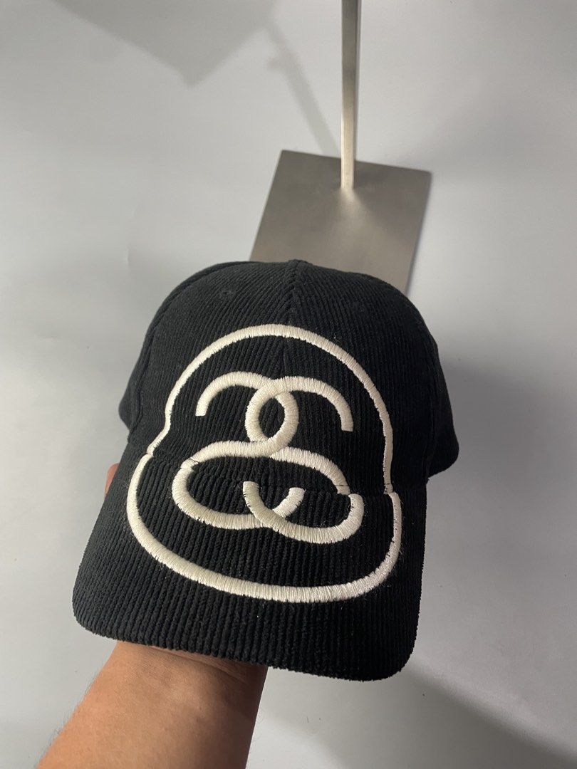 Stüssy Black Corduroy Cap (Category: Caps & Hats) located in Veruela. Submitted by blinkban_thrift (Listing ID 1466575791, Image 1). Description: - Brand: Stüssy - Style: Black corduroy hat with white embroidered logo - Collection: Spring '24 (Style #1311088) - Material: 100% polyester - Fit: One size fits all with adjustable strap closure - Condition: Clean all around, excellent pre-loved condition.
