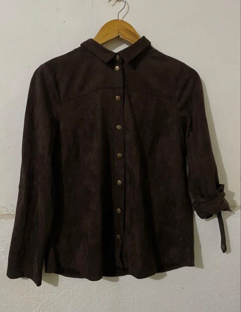 Suede Button-Up Shirt (Category: Shirts) located in Naga. Submitted by cozydapper (Listing ID 1466627207, Image 2). Description: Length - 23 inches Width - 19 inches - Brand: V. Lane - Color: Rich dark brown - Material: Smooth suede-feel fabric - Design: Classic collar and metallic button-up front - Sleeves: Long with button-secured roll-up tabs - Styling: Great for layering or standalone wear in cooler weather.