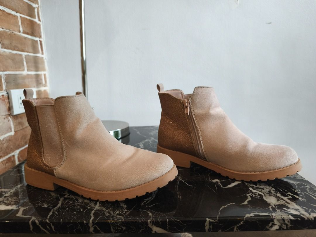 Suede Light Pink Low cut boots (Category: Boots) located in Pasig City. Submitted by rai_ph (Listing ID 1466632121, Image 3). Description: - Color/Material: Beige suede-like - Design: Sparkly gold glitter on back heels - Closure: Convenient side zipper for easy on/off - Sole: Chunky rubber soles with good grip - Condition: Clean overall with minimal signs of wear on soles - Perfect for: Everyday wear, colder days, or going out.