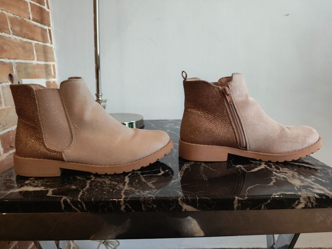 Suede Light Pink Low cut boots (Category: Boots) located in Pasig City. Submitted by rai_ph (Listing ID 1466632121, Image 2). Description: - Color/Material: Beige suede-like - Design: Sparkly gold glitter on back heels - Closure: Convenient side zipper for easy on/off - Sole: Chunky rubber soles with good grip - Condition: Clean overall with minimal signs of wear on soles - Perfect for: Everyday wear, colder days, or going out.