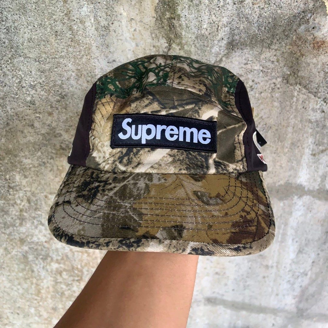 Supreme Mossy Oak Gore-Tex Camp Cap (Category: Caps & Hats) located in Mandaluyong City. Submitted by dhanlumanas (Listing ID 1466770793, Image 1). Description: - Brand: Supreme - Style: Camp Cap in Real Tree Camo with solid brown side panels - Branding: Classic box logo on front, Mossy Oak logo on one side, and Gore-Tex embroidery on the other - Closure: Adjustable strapback with Supreme-branded buckle - Size: Small/Medium - Condition: Brand new
