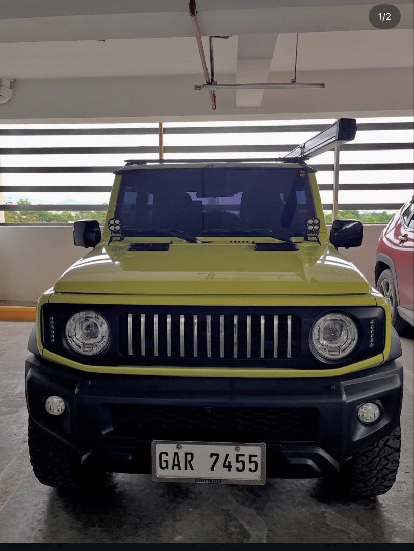 Suzuki Jimny GLX AT Auto (Category: Used Cars) located in Consolacion. Submitted by jl_ua (Listing ID 1466613433, Image 1). Description: Selling my 2022 Suzuki Jimny GLX, top-of-the-line variant, with only 27,000 km mileage. Well-maintained and upgraded for both daily driving and weekend adventures, featuring an upgraded multimedia system, 360° Sony camera, front/rear dashcam with rearview. mirror camera, Roadcruza mud-terrain tires, and a 2.5 × 