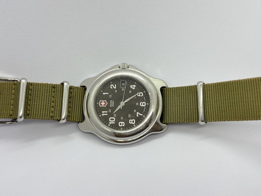 Swiss military field watch (Category: Men's Watches) located in Quezon City. Submitted by rentoti (Listing ID 1466722316, Image 2). Description: Classic Vintage 1990s Victorinox Swiss Army Officer’s Field Watch This timepiece features the iconic military aesthetic with a rare dark green dial and true vintage tritium hour markers (indicated by the original “T SWISS MADE T” stamp on the dial). Perfect for a rugged daily wear option, a classic Every