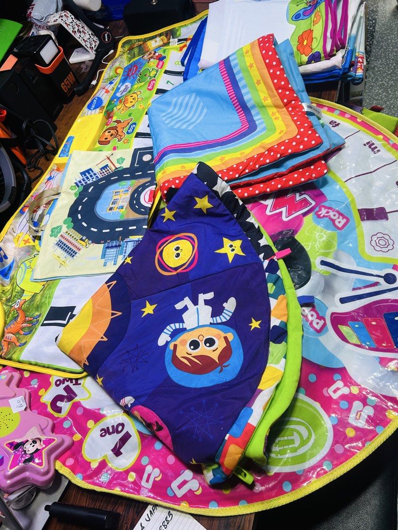Take All Multicolor foldable baby play mats and activity blankets (Category: Infant Playtime) located in Manila. Submitted by starbalesukandjapansurplus (Listing ID 1466587589, Image 1). Description: - Bundle of colorful baby play mats and activity blankets - Features fun themes: space, city roads, rainbows, and animals - Soft, padded material perfect for tummy time and crawling - Easy to fold up and store away - Multiple designs included in the 
