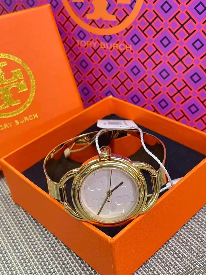TB Gold Bangle Watch with White Dial (Category: Women's Watches) located in Manila. Submitted by bagsandmanymanymore1 (Listing ID 1466585876, Image 1). Description: - Brand: TB Bangle Watch - Style: Gold-tone bangle cuff watch with secure closure - Dial: White dial with iconic double T logo pattern - Condition/Inclusions: Comes with original orange presentation box and swing tag .