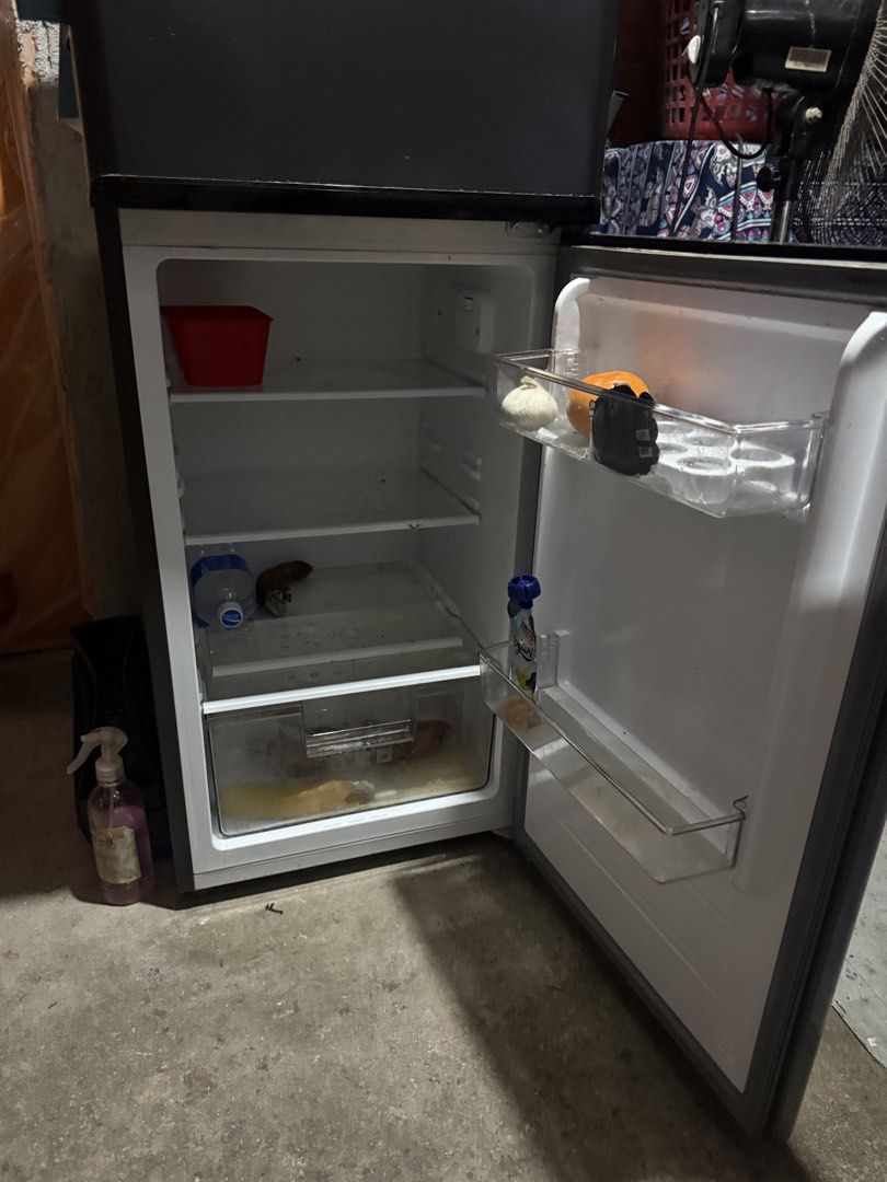 TCL TRF-118PH Two Door Refrigerator (Category: Refrigerators and Freezers) located in Cainta. Submitted by houki (Listing ID 1466571070, Image 3). Description: For Sale: TCL Compact Double Door Refrigerator (TRF-118PH) Bought last April 2026. - Color: Sleek Dark Silver finish - Capacity: 112L total storage (82L fridge / 30L freezer) - Voltage: 220-240V - Inclusions: Complete with interior shelves and door bins - Condition: Normal wear on the exte