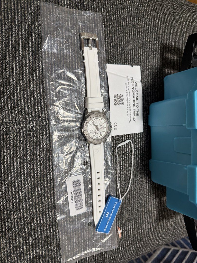 TechnoMarine watch TM-725012 with box and tag (Category: Luxury Watches) located in Manila. Submitted by mackymeeeh (Listing ID 1466720791, Image 1). Description: - Brand: TechnoMarine chronograph watch (Model: TM-725012) - Condition: Unworn, still in protective plastic bag - Design: White dial with sub-dials, silver-tone textured bezel, and white silicone strap - Inclusions: Blue hang tag, manual card, bright blue storage case, and Invicta brand