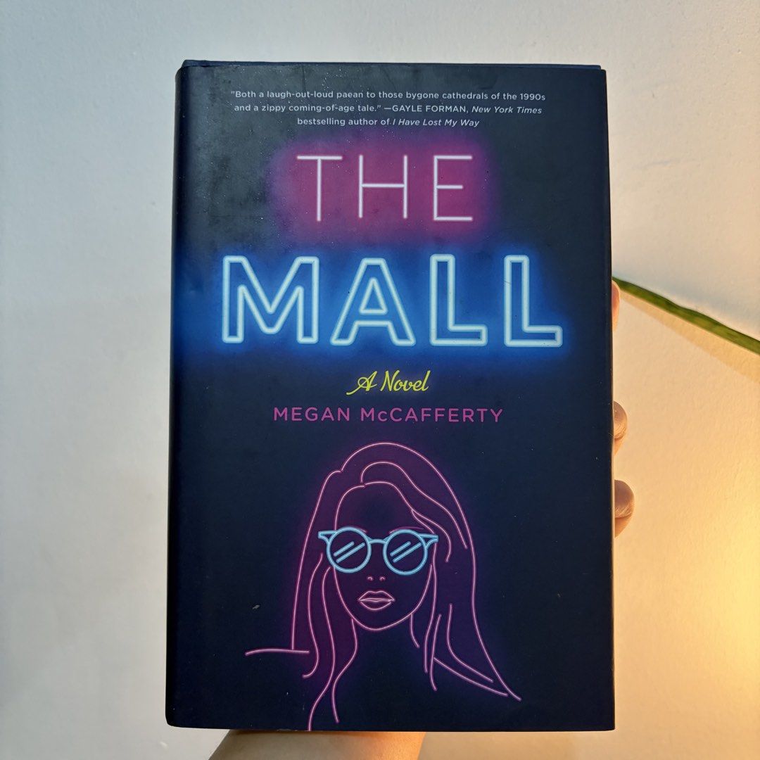The Mall by Megan McCafferty (Category: Storybooks) located in Manila. Submitted by ajdeclutter (Listing ID 1466578721, Image 1). Description: - Format: Hardcover - Publisher: Wednesday Books - Genre: 90s-set fiction novel with a cool neon aesthetic cover .